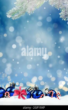 Christmas composition with Christmas balls and gift box on snow. Holiday concept. Stock Photo