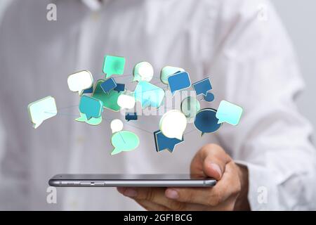 A businessman holding virtual 3D colorful blank speech bubbles Stock Photo