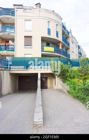 POZNAN, POLAND - May 12, 2021: A vertical shot of an apartment building with a garage Stock Photo