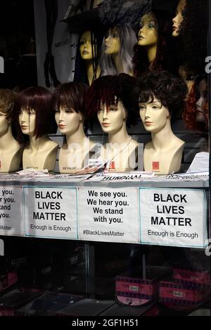 Black lives matter sign in front window of a wig store in Brooklyn NYC Stock Photo Alamy