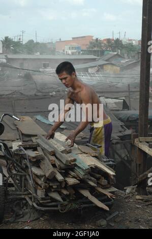 MANILA, PHILIPPINES - Oct 20, 2011: A man working in Smoky ountain village, Manila, Philippines Stock Photo