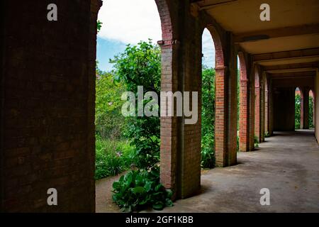 Standing under the brick terrace walkways at The Hill Garden and Pergola, Hampstead Heath, London, UK Stock Photo