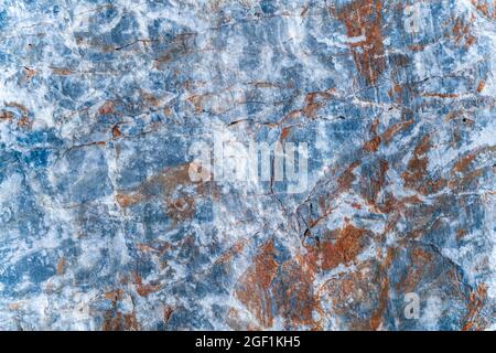 Texture of rusty orange plaque on gray stone slab with white pattern. Top view. Stock Photo