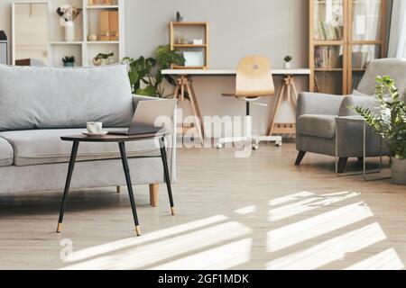 Background image of cozy home interior lit by sunlight with focus on comfortable couch, copy space Stock Photo
