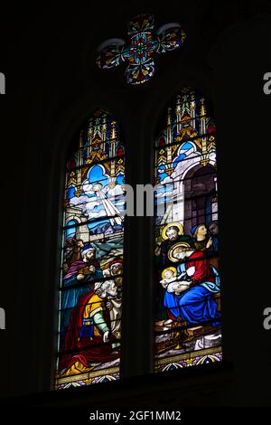 Colorful stained glass windows filled with art from a Catholic church. Salvador Bahia Brazil. Stock Photo