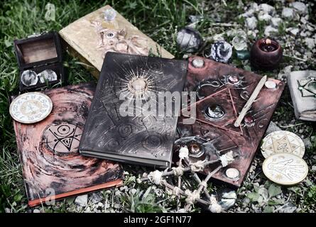 Grunge still life with magic books, witch objects, pentagram and candle.  Esoteric, gothic and occult background, Halloween mystic and wicca concept o Stock Photo