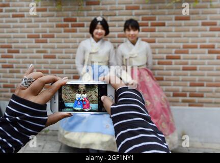 Chinese tourist dressed in traditional Korean dress in the Bukchon Hanok village in Seoul, Korea. Stock Photo