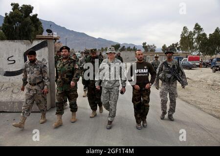 U.S. Army Lt. Col. Frederick O'Donnell, center, Commander of 1st Battalion, 32nd Infantry Regiment, 3rd Brigade Combat Team, 10th Mountain Division, walks with Afghan border patrol Col. M. Ayoob Hussainhil, right, and Afghan national army Lt. Col. Ishaq Tamkim to the ground breaking ceremony for the Ghulam Mohammad Sports Complex in the Sarkani District of Kunar province, Afghanistan, Dec. 12, 2009. Stock Photo