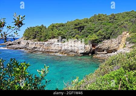 beautiful bay in croatia on the adriatic sea with stone cliffs and turquoise blue water Stock Photo