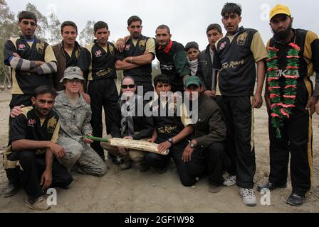 U.S. Army Lt. Col. Frederick O'Donnell poses for a photo with the Sarkani local cricket team 'The Knight Riders' after the ground breaking ceremony for the Ghulam Mohammad Sports Complex in the Sarkani District of Kunar province, Afghanistan, Dec. 12, 2009. O'Donnell is the commander of 1st Battalion, 32nd Infantry Regiment, 3rd Brigade Combat Team, 10th Mountain Division. During his speech O'Donnell said, 'In the United States we don't agree on everything, but sports is one the things that bring us of together. He knows that Afghan people love cricket and this project is for the people.' Stock Photo