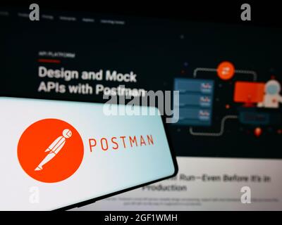 Smartphone with logo of US collaboration platform company Postman Inc. on screen in front of business website. Focus on left of phone display. Stock Photo