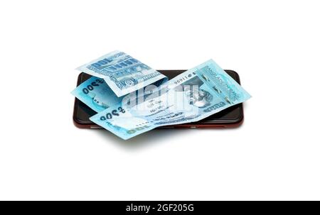 Two folded one hundred taka bangladesh banknotes above a smartphone on an isolated white background Stock Photo