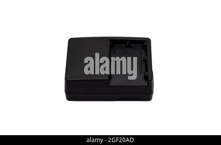 Old used black camera charging adapter on isolated white background Stock Photo