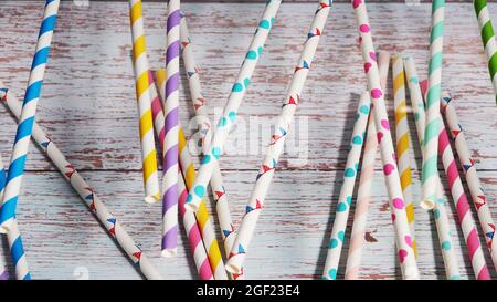 Many colorful paper cocktail tubes lie as a background. Stock Photo