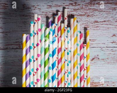 Many colorful paper cocktail tubes lie as a background. Stock Photo