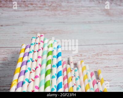 Many colorful paper cocktail tubes lie as a background. Stock Photo