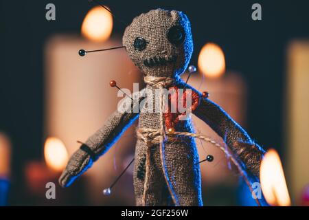Voodoo Magic concept. Witchcraft with Voodoo doll. Close-up of rag puppet nipped with needles. Stock Photo