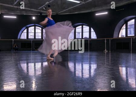 Young ballet dancer dressed in a tutu practices her dance in a rehearsal hall in Saint Petersburg in preparation for a performance. Stock Photo