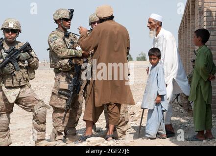 U.S. Army soldiers from Troop C, 4th Squadron, 9th Cavalry Regiment, 2nd Brigade Combat Team, 1st Cavalry Division, speak with locals during a reconnaissance mission in a village south of Forward Operating Base Fenty, Nangarhar province, Afghanistan, Sept. 8, 2013. The purpose of the mission was to encourage communication between the local community and coalition forces in order to thwart enemy operations. (U.S. Army National Guard photo by Sgt. Margaret Taylor, 129th Mobile Public Affairs Detachment/RELEASED) Stock Photo