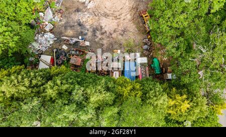 Aerial view of abandon yard with few vehicles left to rot.