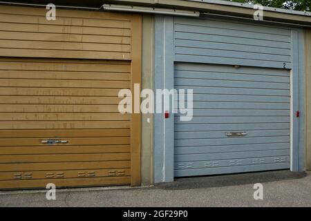 Weathered brown and blue colored corrugated metal garage gates Stock Photo