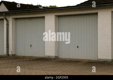 Weathered gray-colored corrugated metal garage gates Stock Photo
