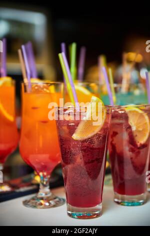 Multicolored alcoholic and non-alcoholic cocktails with ice and straws Stock Photo