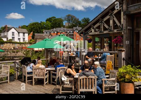 UK Wales, Clwyd, Llangollen, Old Corn Mill, (Melin Yd) cafe beside River Dee, customers in sunshine Stock Photo