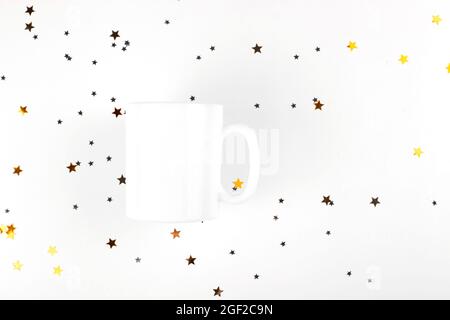 White empty cup mockup on light background with gold stars. Minimalistic mug mock up layout Stock Photo