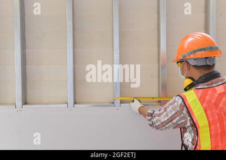 Selective focus of handsome man in goggles and apron in workshop,Carpenter working Stock Photo