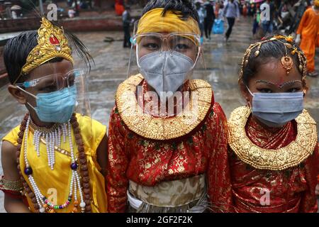 Kathmandu, NE, Nepal. 23rd Aug, 2021. Children, clad in traditional attires, wear protective masks and face shields during the Gai Jatra festival celebration in Kathmandu, Nepal, August 23, 2021. This annual festival is marked in a rememberance of deceased family members and relatives. (Credit Image: © Aryan Dhimal/ZUMA Press Wire) Stock Photo