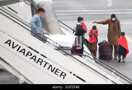 People disembark at the arrival of a chartered Air Belgium airplane carrying evacuated people from Afghanistan, at the military airport in Melsbroek, Stock Photo