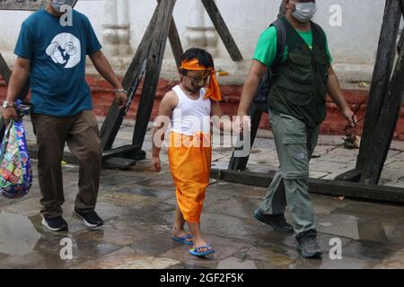 Kathmandu, NE, Nepal. 23rd Aug, 2021. Children, clad in traditional attires, wear protective masks and face shields during the Gai Jatra festival celebration in Kathmandu, Nepal, August 23, 2021. This annual festival is marked in a rememberance of deceased family members and relatives. (Credit Image: © Aryan Dhimal/ZUMA Press Wire) Stock Photo