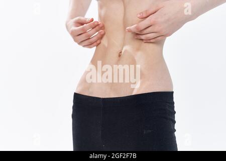 woman with flat stomach health problems anorexia weight loss Stock Photo