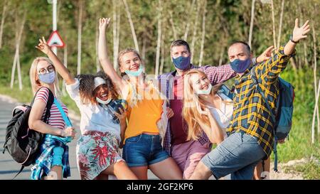 Happy mixed race group of best friends embracing and having fun on trip adventure Happy mixed race group of best friends embracing and having fun on t Stock Photo