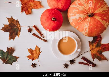 Pumpkin smoothie, spice latte. Boozy cocktail with cinnamon sticks anise stars. Maple leaves decorations. Autumn seasonal hot drinks. Thanksgiving day Stock Photo