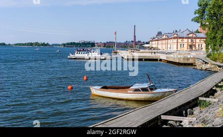 Vaasa, Finland: 28 July, 2021: Vaasa harborfront with the old harbormaster building and several boats at the docks Stock Photo