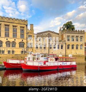 Tourist cruise boats on River Ouse moored outside the Guildhall, York, UK. Stock Photo