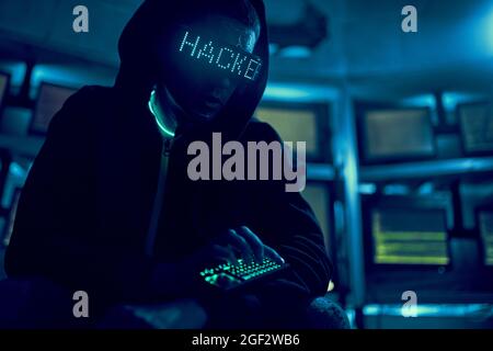 Cyber hacker breaks into databases to obtain information using a computer. Cybercrime and data security concept. Stock Photo