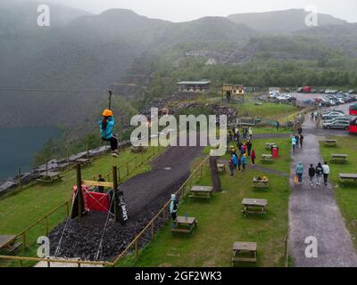 Girl going down the Quarry Flyer at Zip World Adventure Bethesda Gwynedd North Wales UK Stock Photo