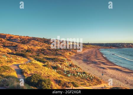 Coastal view of Hallett Cove with the beach and houses at sunset. Sugarloaf is visible on the left Stock Photo