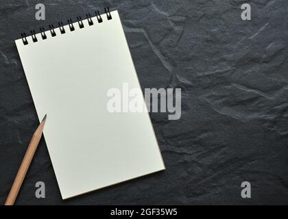 Top Table View, Open Blank Spiral Notebook On Black Background, Copy Space for Text. Stock Photo