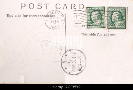 Vintage postcard with two one cent stamps and postmarks of 1909