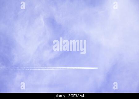 Low angle shot of an airplane flying in the sky of Moscow and its trajectory Stock Photo