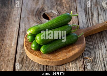 fresh ripe cucumbers on wood background Stock Photo