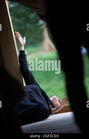 solo dancer move laying on the floor in contemporary improvisation performance on nature bg Stock Photo