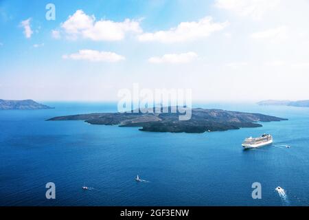 Aerial view of modern luxury tourist cruise ship in the bay of Santorini, Greece Stock Photo