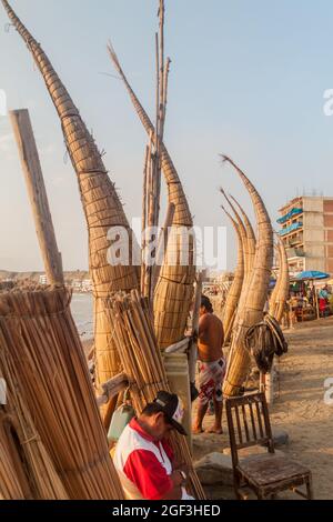 HUANCHACO, PERU - JUNE 6, 2015: Traditional reed boats on a beach in Huanchaco, Peru. Stock Photo