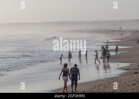 HUANCHACO, PERU - JUNE 7, 2015: People on a beach in Huanchaco, Peru. Stock Photo