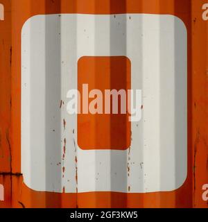 Grunge single letter O on an orange corrugated enameled metal background Stock Photo
